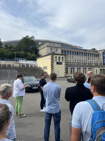 Menschen von hinten, im Hintergrund RB Leipzig