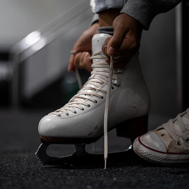 Girl putting on ice skates