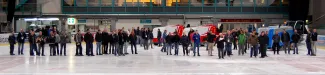 Ice rink inside - attendees inspecting ice resurfacers