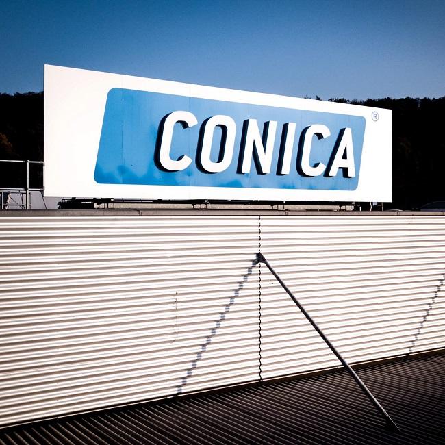 Conica-factory building with ad